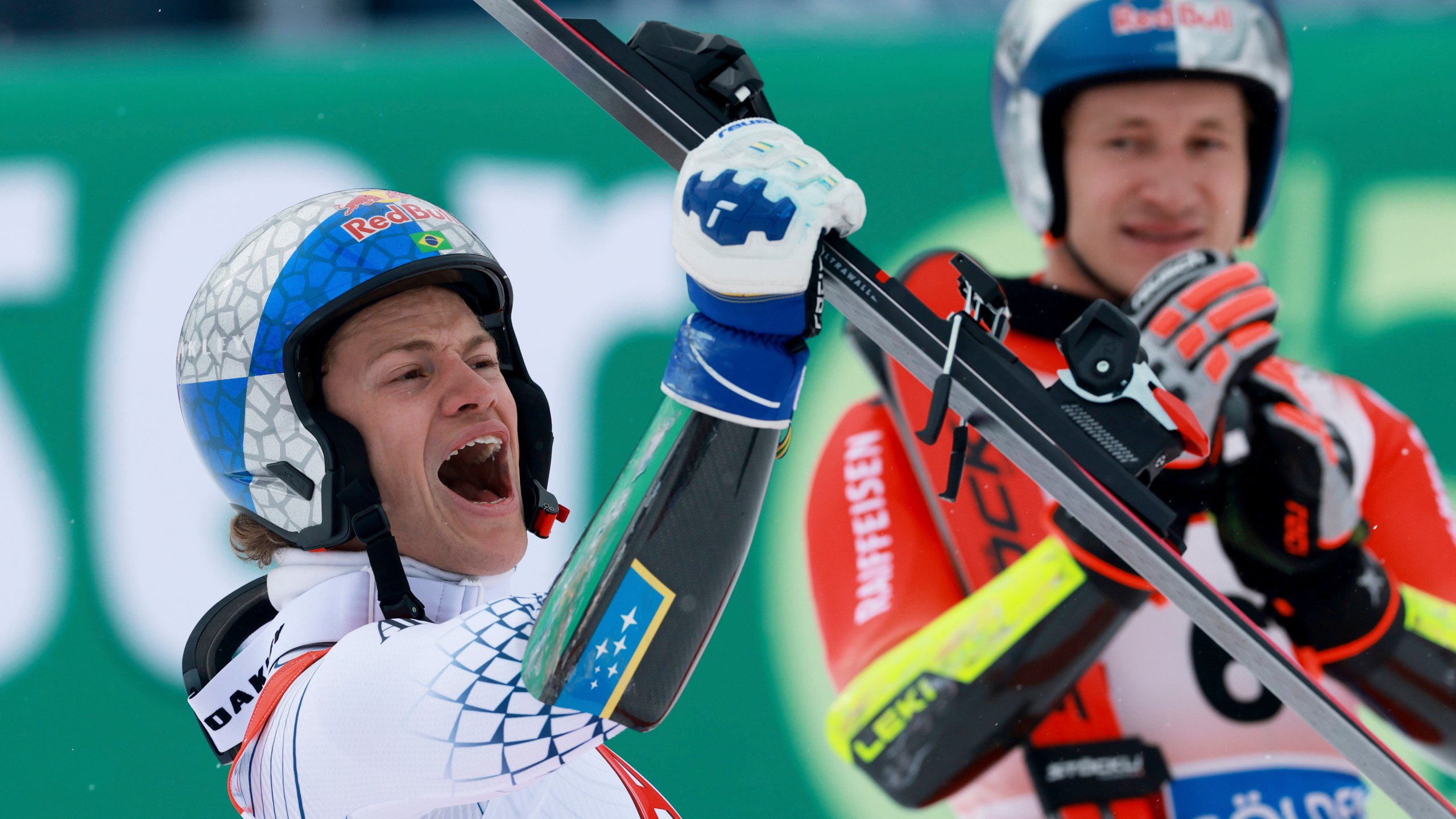 Brazil's Lucas Pinheiro Braathen celebrates winning an alpine ski, men's World Cup giant slalom as third-placed Switzerland's Marco Odermatt applauds in the background, in Soelden, Austria, Sunday, Oct. 25, 2026. (AP Photo/Alessandro Trovati)