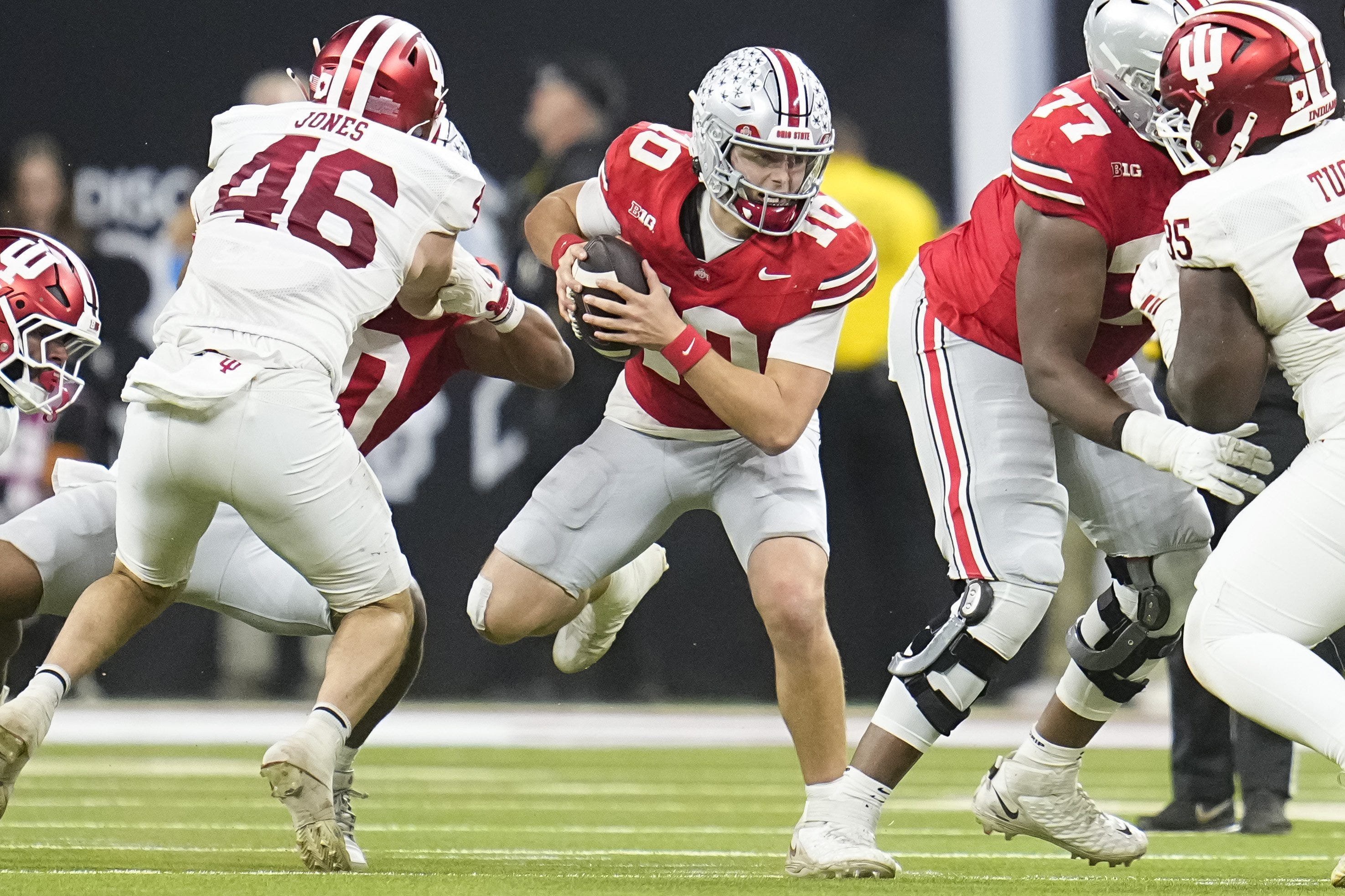 Ohio State Buckeyes quarterback Julian Sayin (10) scrambles during the first half of the Big Ten Conference championship game against the Indiana Hoosiers at Lucas Oil Stadium in Indianapolis on Dec. 6, 2025.