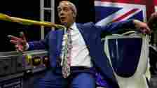 Nigel Farage speaks to reporters on the top of the bus