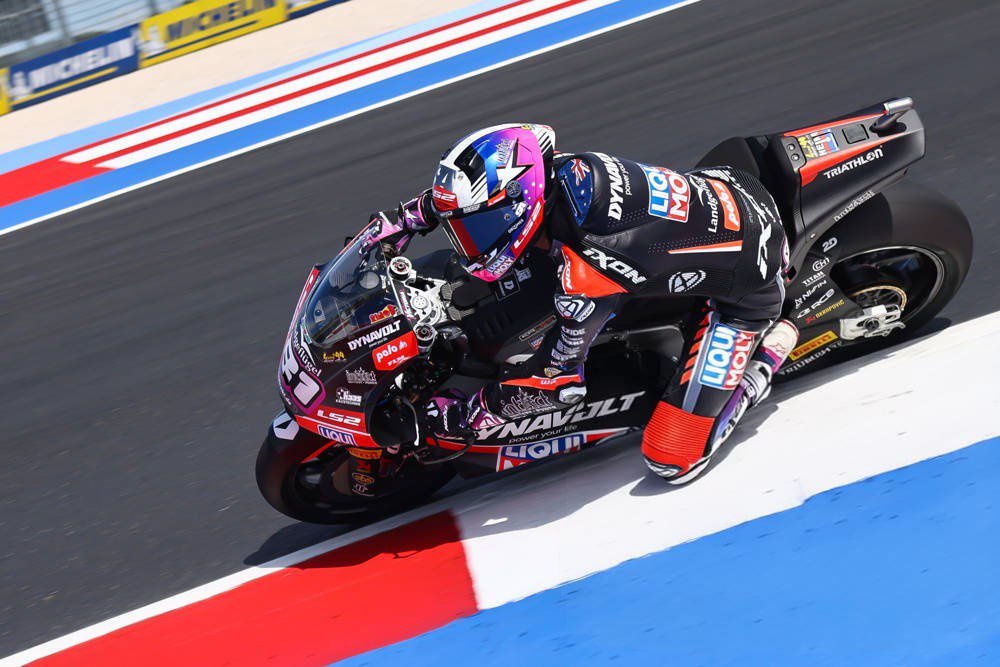 Senna Agius on his Tech3 MotoGP bike leaning into a corner at a MotoGP track with red-white-blue kerbs and Michelin banners