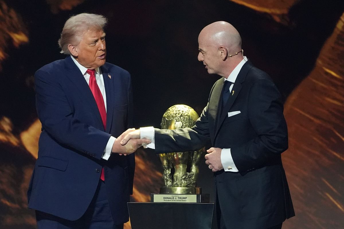 President Donald Trump shakes hands with FIFA President Gianni Infantino as he presented with the inaugural FIFA Peace Prize during the 2026 FIFA World Cup draw at the Kennedy Center, Dec. 5, 2025, in Washington