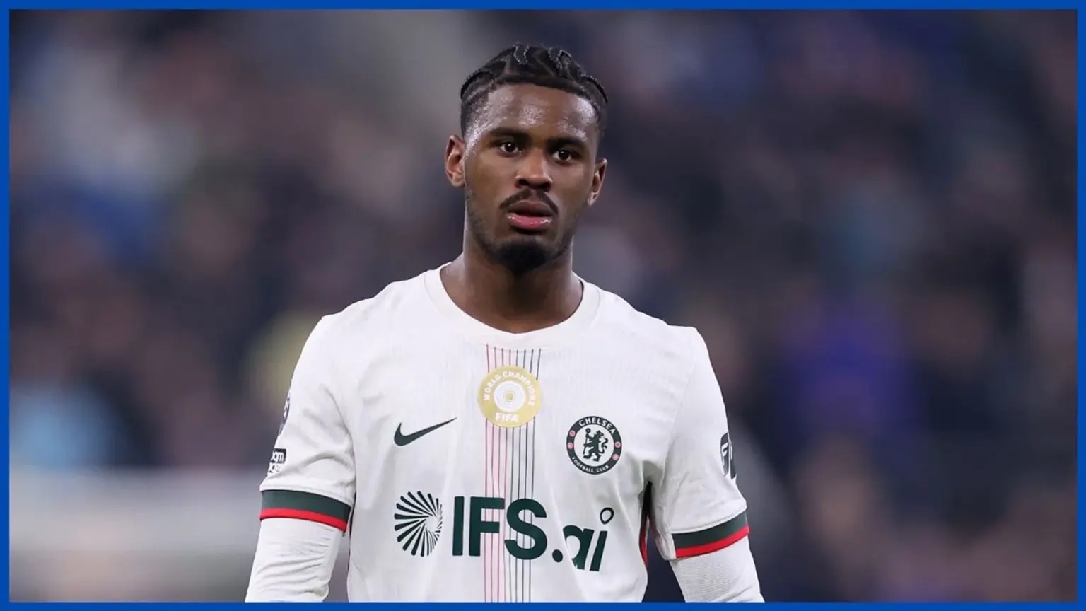 Jorrel Hato wearing a white Chelsea FC kit during a match.