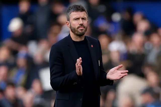 Michael Carrick, Manager of Manchester United, applauds the fans