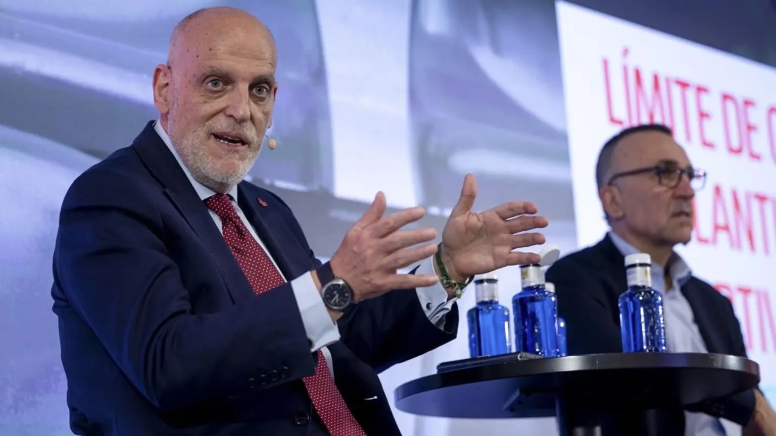 Javier Tebas speaking at a press event, gesturing with his hands.