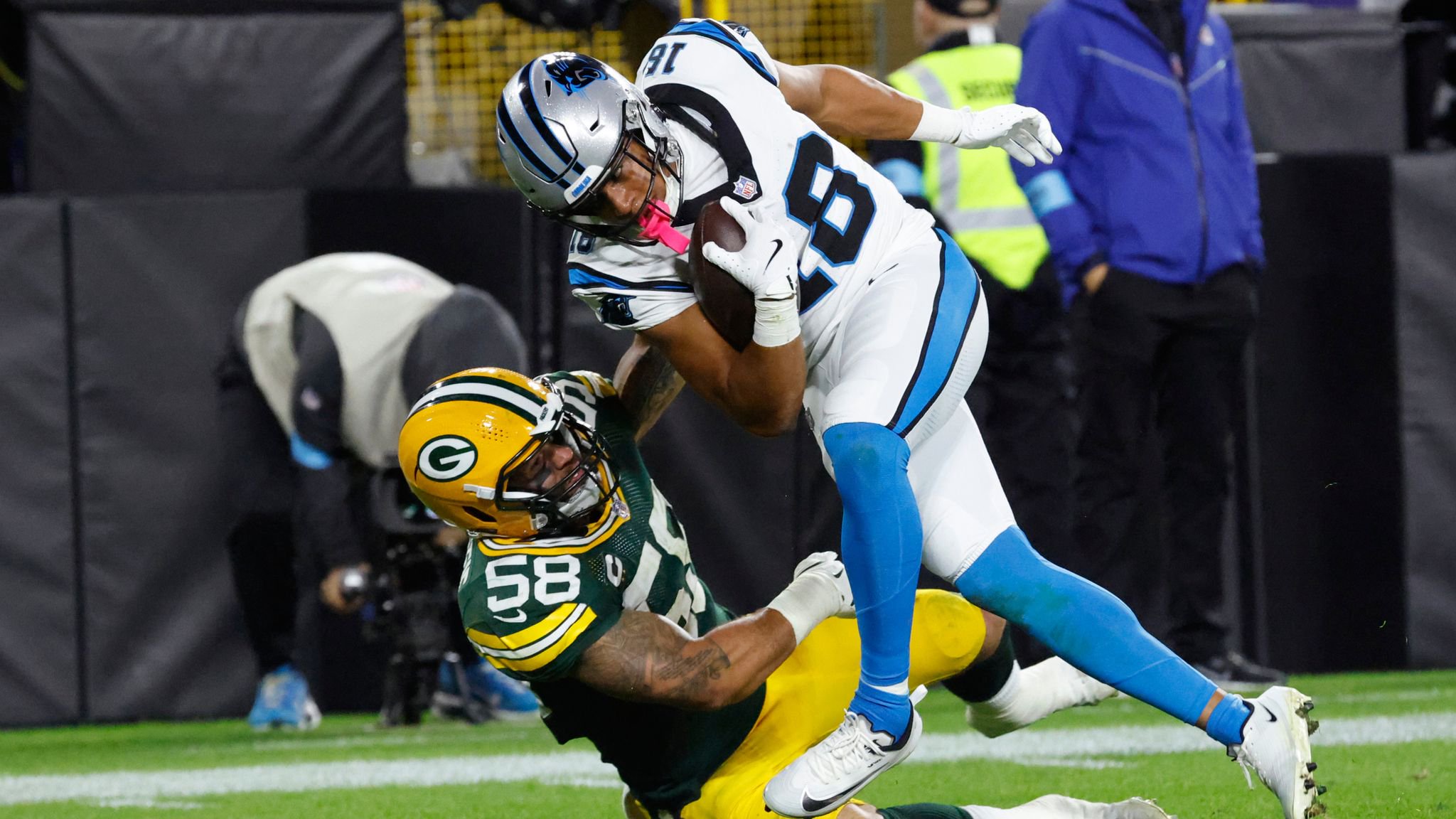 Carolina Panthers wide receiver Coker (18) scores a touchdown over Green Bay Packers linebacker McDuffie 