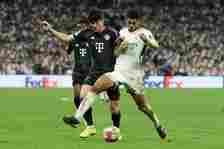 Jude Bellingham of Real Madrid, left Kim Minjae of Bayern Munich in action during the UEFA Champions League semi-final second leg match between Rea...
