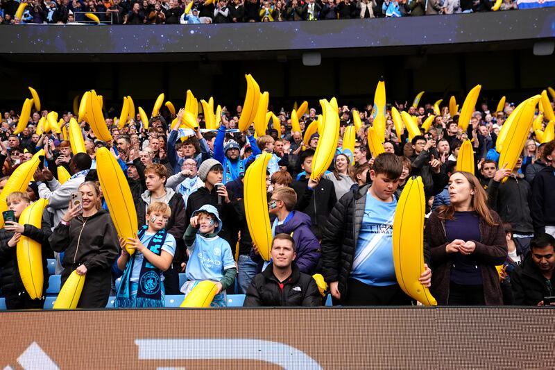 Manchester City fans with inflatable bananas in the stands ahead of the Premier League match against Ipswich