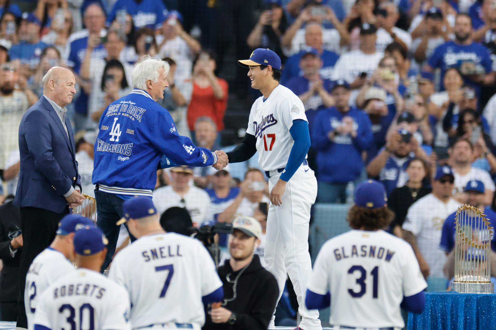 Shohei Ohtani receives his World Series ring from Mark Walter at Dodger Stadium