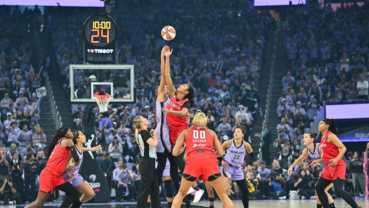 Angel Reese jumps for the opening tip against the Golden State Valkyries.