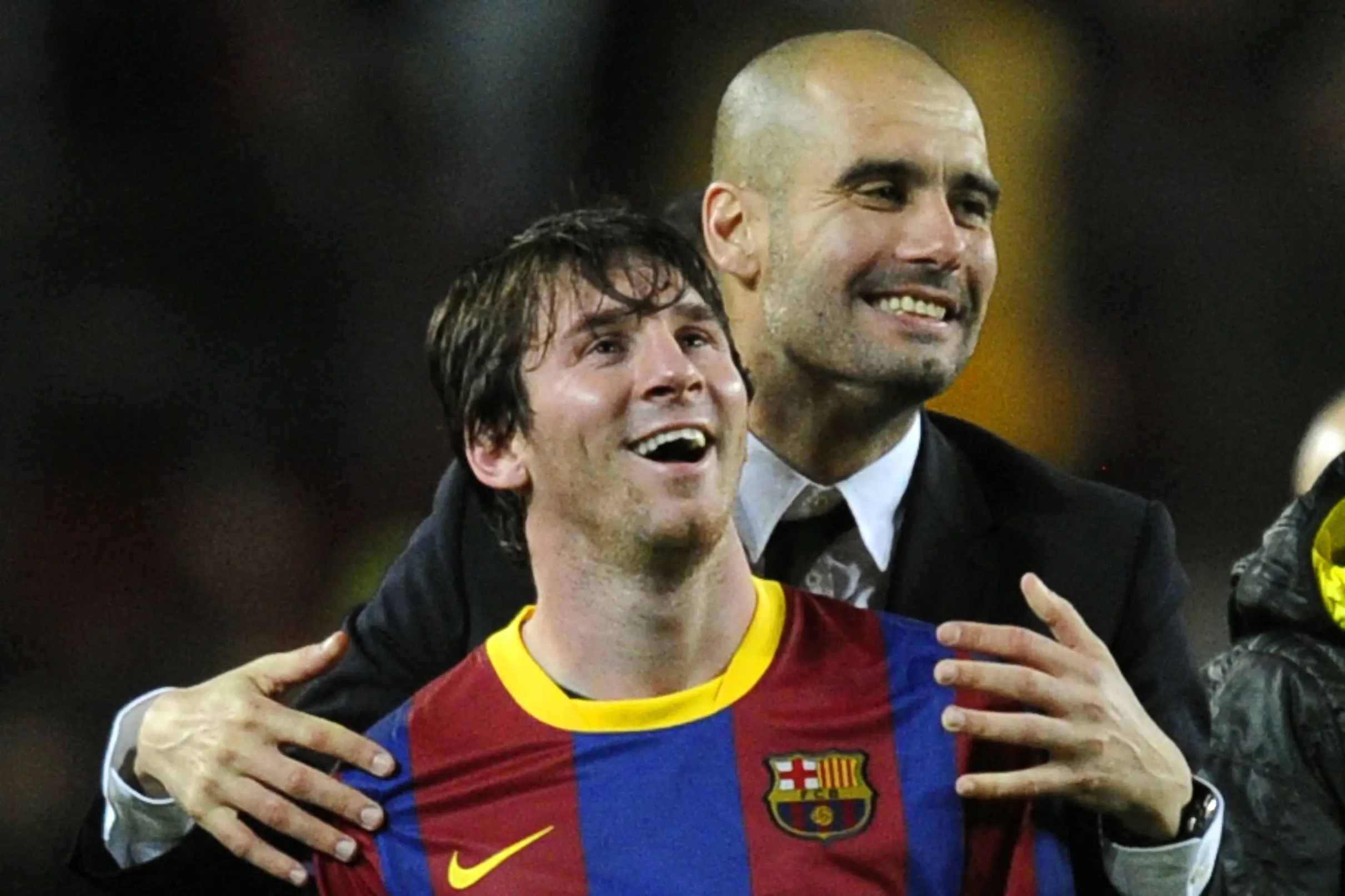 Lionel Messi and Pep Guardiola smiling.