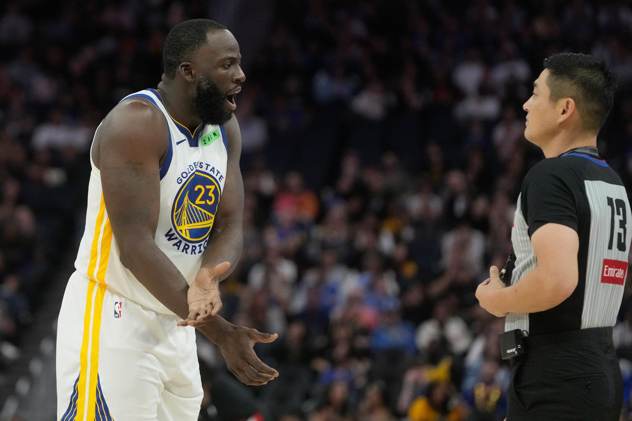Golden State Warriors forward Draymond Green reacts toward referee Intae Hwang during a game.