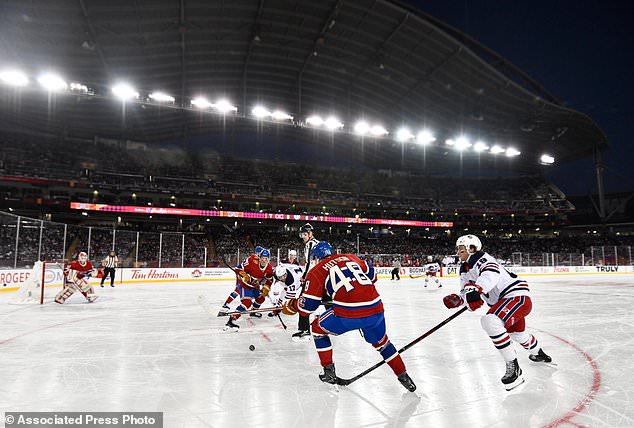 The Winnipeg Jets and the Montreal Canadiens play during the first period of the NHL Heritage Classic hockey game in Winnipeg, Manitoba, Sunday, Oct. 25, 2026. (Fred Greenslade/The Canadian Press via AP)