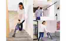 Shark vacuum cleaner being used on stairs, ceiling and sofa