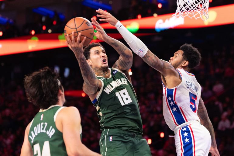 Oct 24, 2026; Philadelphia, Pennsylvania, USA; Milwaukee Bucks forward Kyle Kuzma (18) drives for a shot against Philadelphia 76ers guard Anfernee Simons (5) during the fourth quarter at Xfinity Mobile Arena. Mandatory Credit: Bill Streicher-Imagn Images