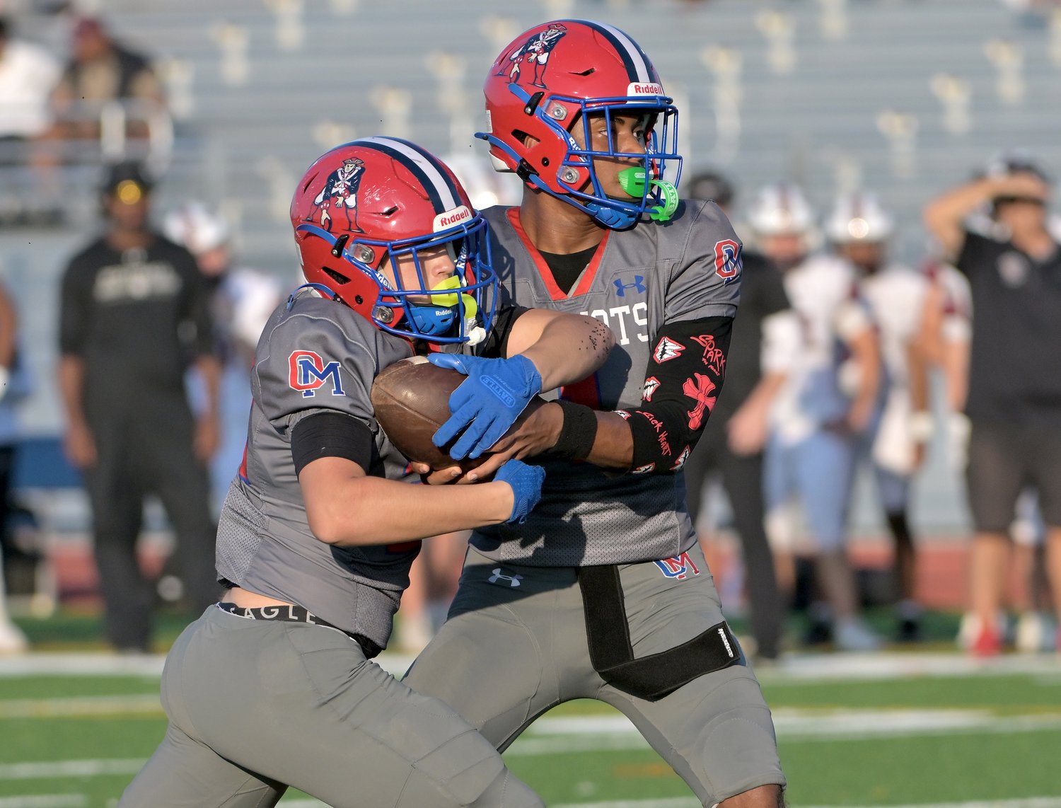 Old Mill Patriots Tyler McConville #22 takes the handoff from quarterback Braylon Tucker #1 in the second quarter. The Old Mill Patriots host the visiting Broadneck Bruins in high school football at the Severn Run High School. (Paul W. Gillespie/Staff)