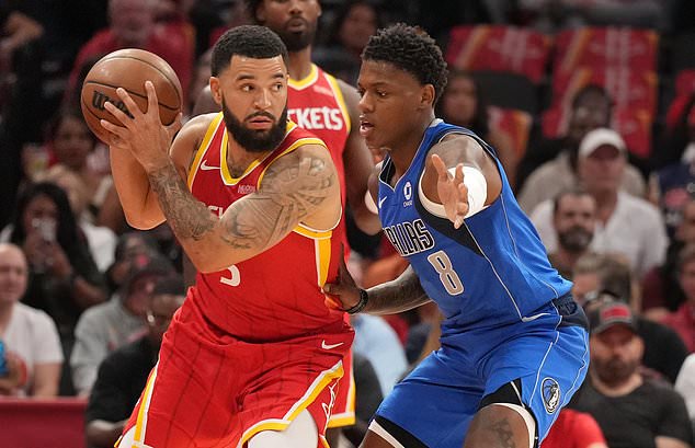 Houston Rockets guard Fred VanVleet, left, controls the ball against Dallas Mavericks guard Marcus Sasser during the first half of an NBA basketball game, Wednesday, Oct. 21, 2026, in Houston. (AP Photo/Karen Warren)