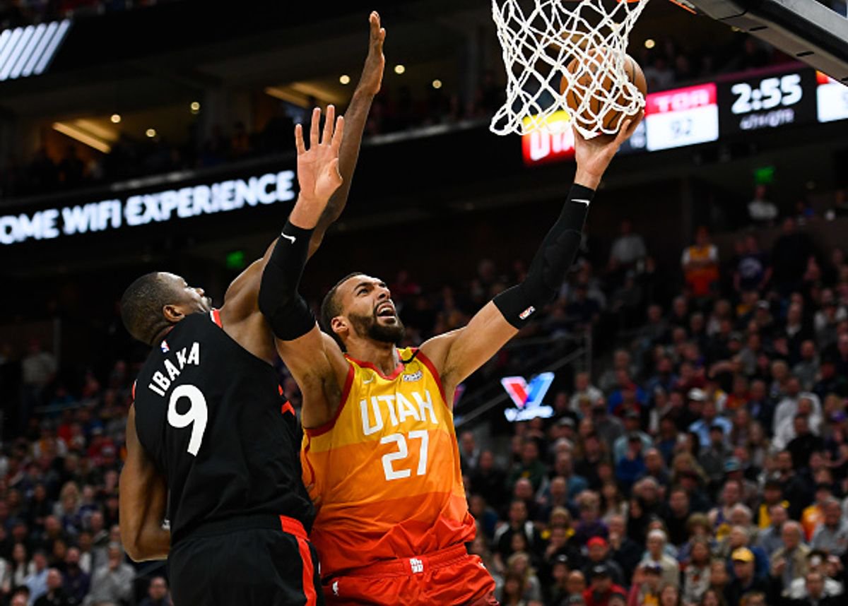 Rudy Gobert #27 of the Utah Jazz attempts a shot under Serge Ibaka #9 of the Toronto Raptors during a game at Vivint Smart Home Arena on March 9, 2020 in Salt Lake City, Utah. NOTE TO USER: User expressly acknowledges and agrees that, by downloading and/or using this photograph, user is consenting to the terms and conditions of the Getty Images License Agreement.  