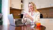 Happy woman texting on smartphone