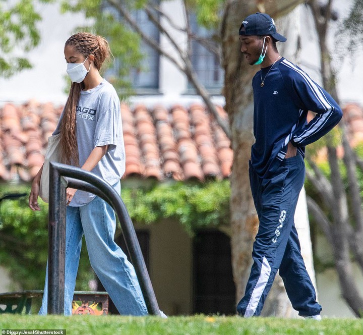 Both Malia, 23, and Clifton, 24, were dressed casually for their laidback outing; former President Barack Obama 's eldest child sported a pair of baggy blue jeans and an oversized grey Chicago White Sox T-shirt in a touching nod to her famous parents.