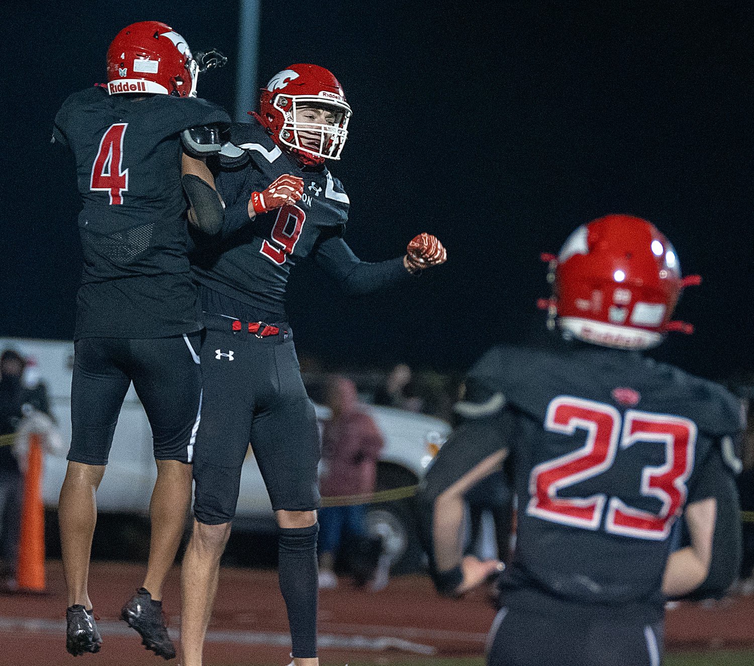 Milton junior Taj Chung, left,  celebrates his touchdown with Milton senior Chaz Putman against Franklin, at Brooks Field in Milton, Oct. 23, 2026.