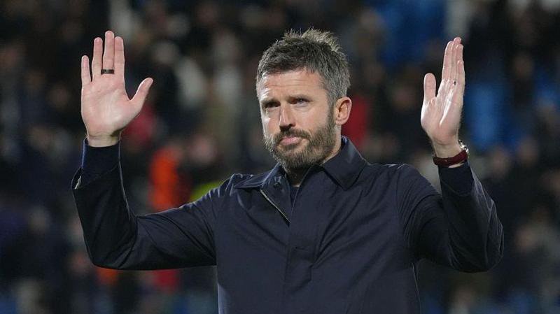 Manchester United manager Michael Carrick making a gesture of apology to fans