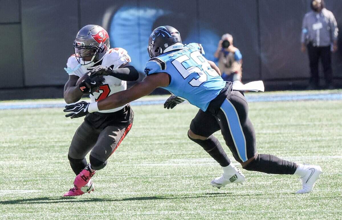 Carolina Panthers linebacker Bobby Okereke reaches to tackle Tampa Bay Buccaneers running back Bucky Irving during the first half of the game Sunday, Oct. 25, 2026 at Bank of America Stadium in Charlotte.
