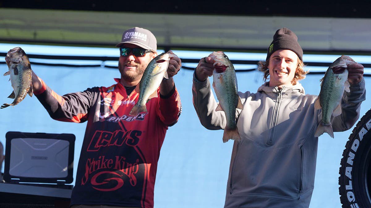 Angler Tristan McCormick and motocross racer Levi Kitchen stand together at a weigh-in event.