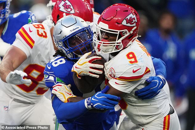Kansas City Chiefs running back Kenneth Walker III (9) is stopped with the ball by Seattle Seahawks linebacker Tyrice Knight (48) during the first half of an NFL football game in Seattle, Sunday, Oct. 25, 2026. (AP Photo/Lindsey Wasson)