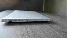 The Asus Vivobook S 15 Copilot+ in silver pictured on a wooden desk.