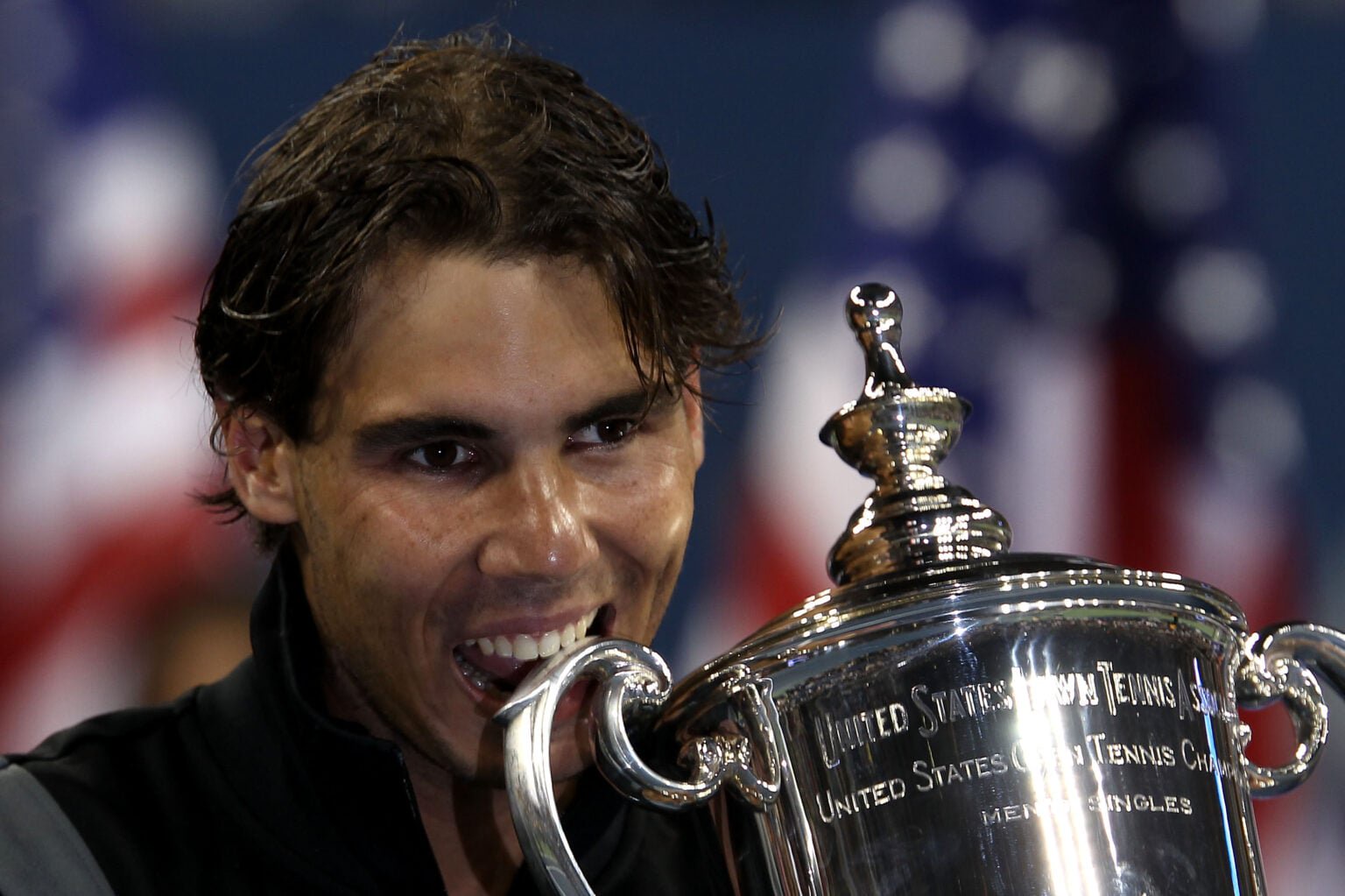 Rafael Nadal biting the US Open trophy in 2010.