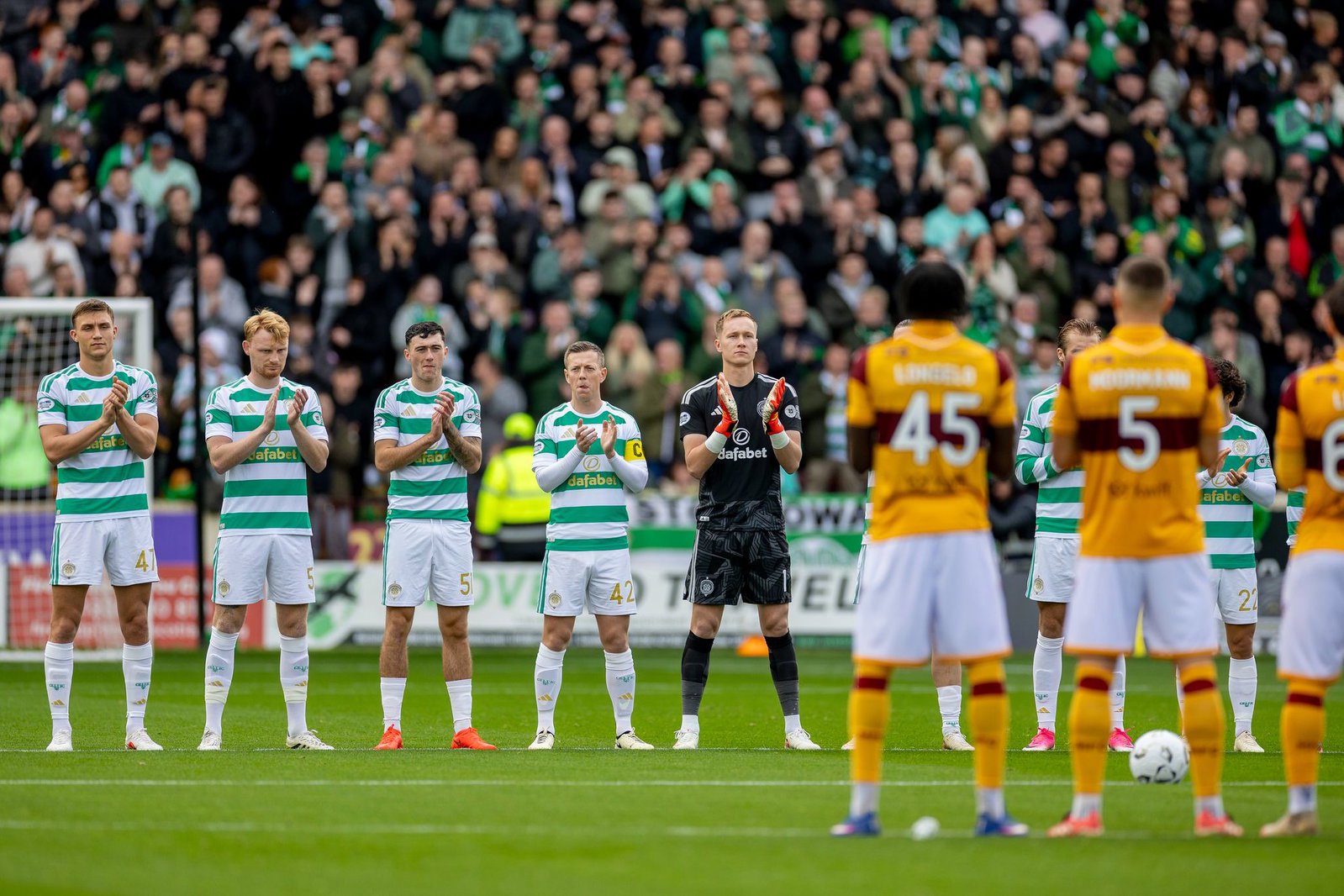 Motherwell and Celtic players line up before kick-off at Fir Park