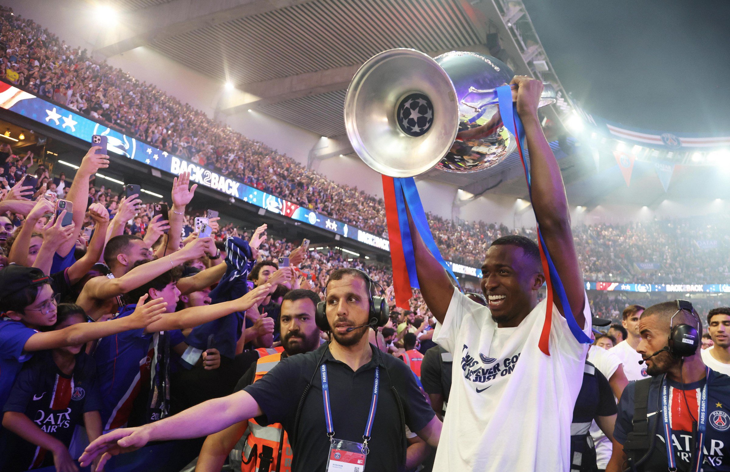 PARIS, FRANCE - MAY 31: Willian Pacho of Paris Saint-Germain parade with trophy during the 2026 Champions League Trophy presentation to the Paris Saint-Germain fans at Parc des Princes on May 31, 2026 in Paris, France. (Photo by Xavier Laine/Getty Images)