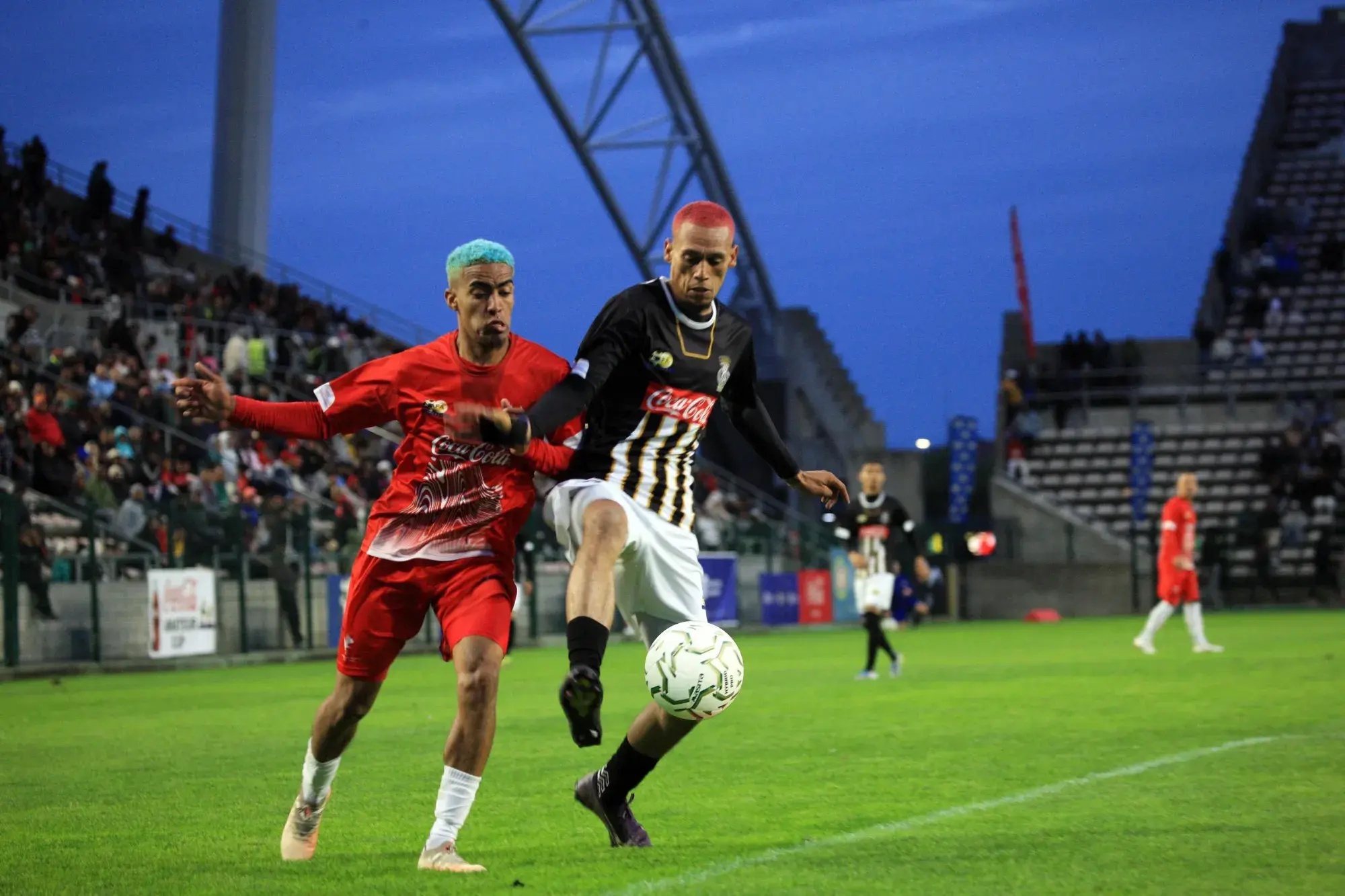 Hanover Park’s Imtiyaaz Ruiters and Saxon Rovers’ Elzade Paulse tussle for possession during their Coke Cup final at Athlone Stadium on Saturday.