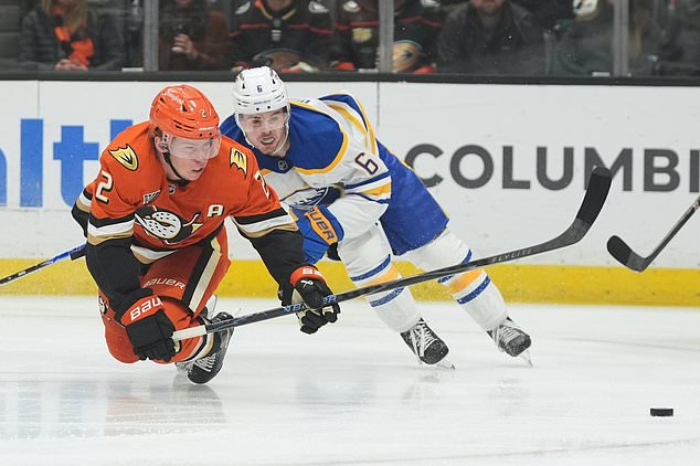 Anaheim Ducks defenseman Jackson LaCombe (2) collides with Buffalo Sabres left wing Zach Benson (6) during the first period of an NHL hockey game Thursday, Oct. 29, 2026, in Anaheim, Calif. (AP Photo/Gregory Bull)