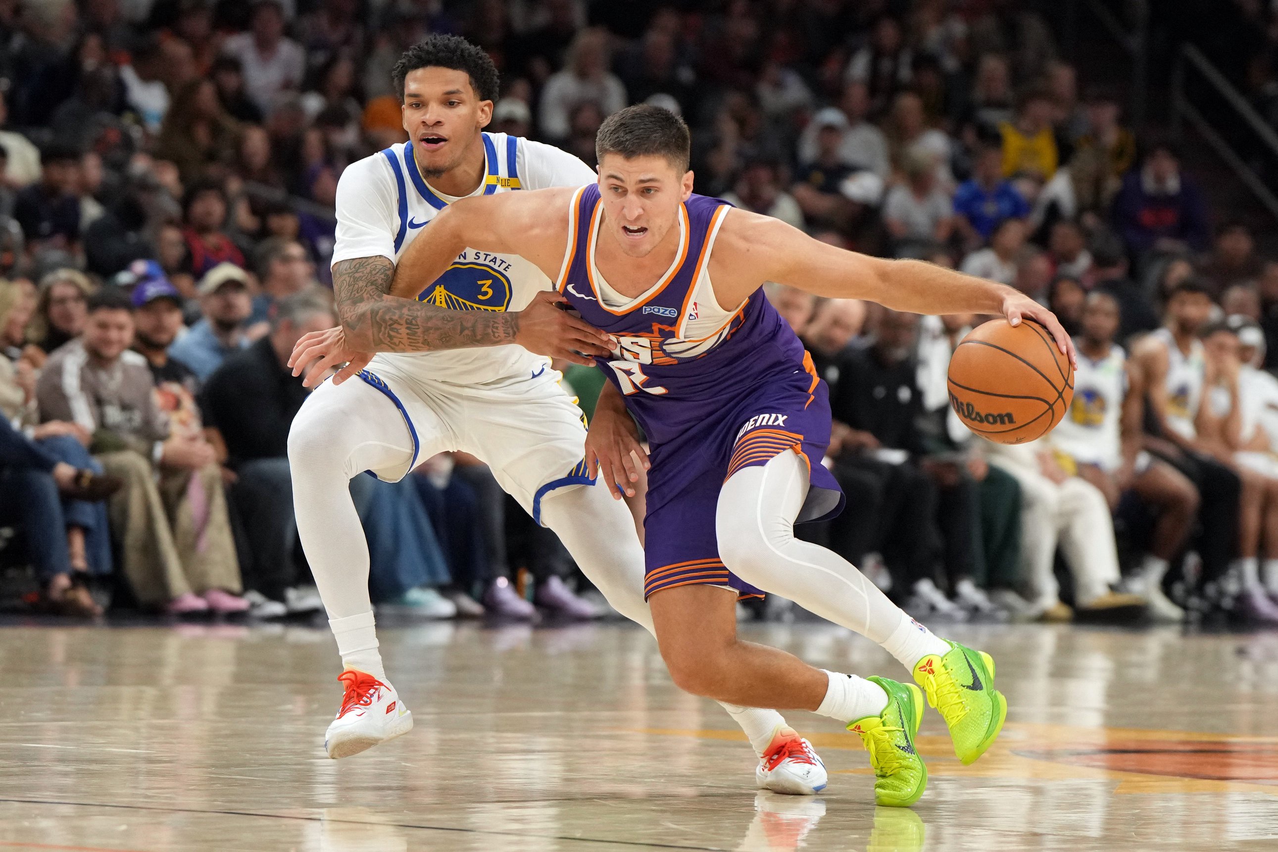 Oct 24, 2026; Phoenix, Arizona, USA;  Phoenix Suns guard Collin Gillespie (12) shields the ball from Golden State Warriors guard Will Richard (3) in the second half at Mortgage Matchup Center.  Mandatory Credit: Rick Scuteri-Imagn Images