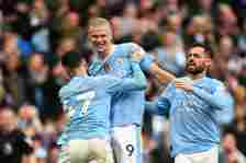  Erling Haaland of Manchester City celebrates scoring his team's fourth goal against Wolves with teammates Phil Foden and Bernardo Silva