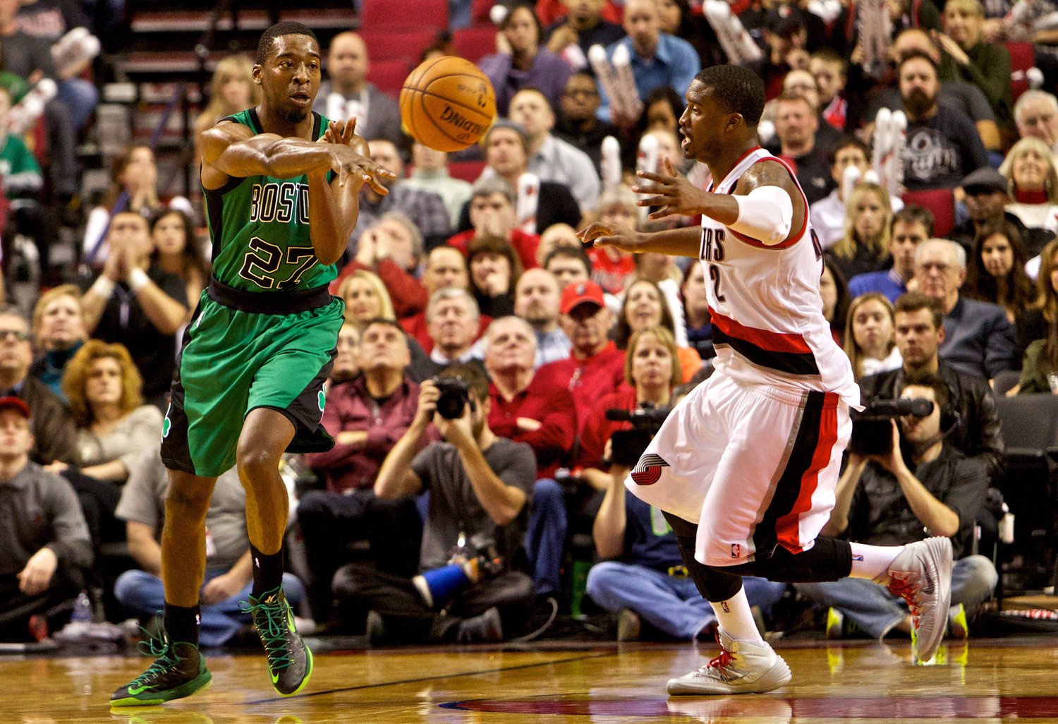 Jan 11, 2014; Portland, OR, USA; Boston Celtics shooting guard Jordan Crawford (27) passes away from Portland Trail Blazers shooting guard Wesley Matthews (2) at the Moda Center. Mandatory Credit: Craig Mitchelldyer-USA TODAY Sports