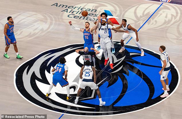 Dallas Mavericks forward Daniel Gafford (21) and Oklahoma City Thunder center Isaiah Hartenstein (55) compete for the opening tip off during the first half of an NBA basketball game Wednesday, Oct. 28, 2026, in Dallas. (AP Photo/Jeffrey McWhorter)