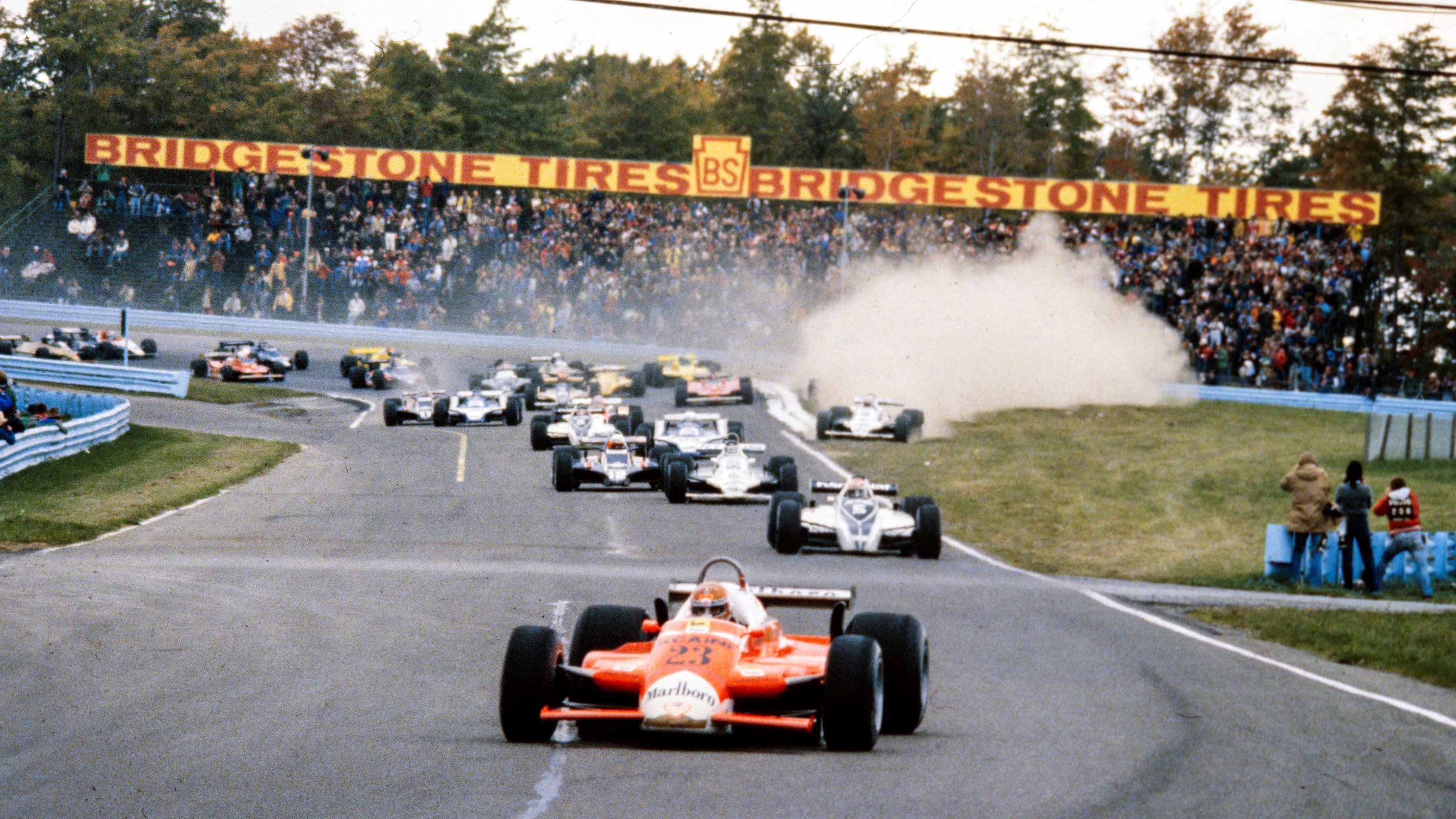 The Williams of Alan Jones throws up dust as it goes wide during the 1980 US Grand Prix at Watkins Glen, with Alfa Romeo's Bruno Giacomelli leading the race