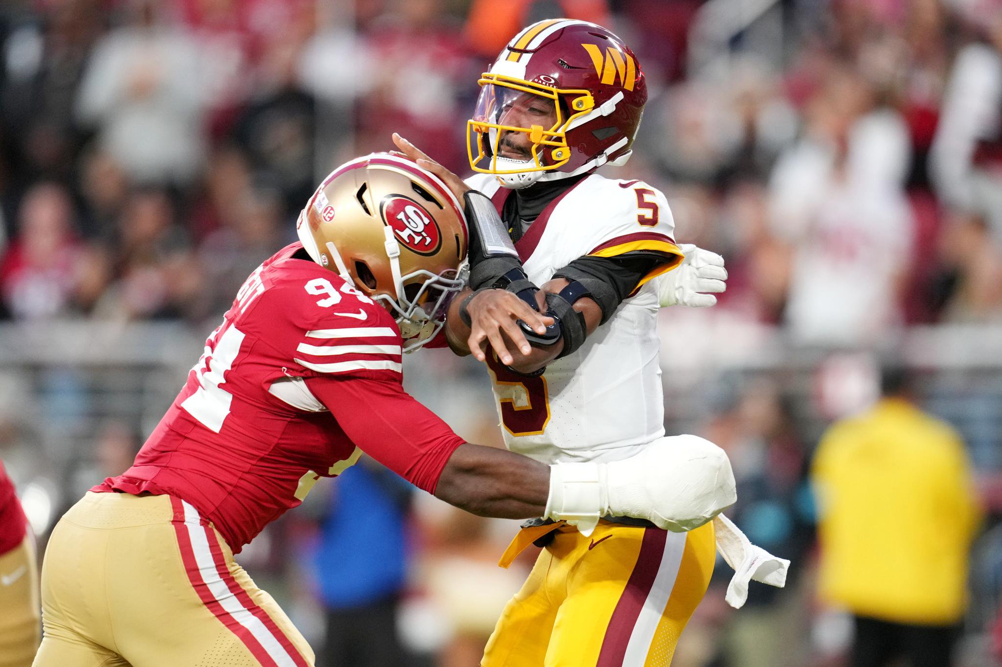 Washington Commanders quarterback Jayden Daniels (5) is hit as he throws by San Francisco 49ers defensive end Romello Height (94).