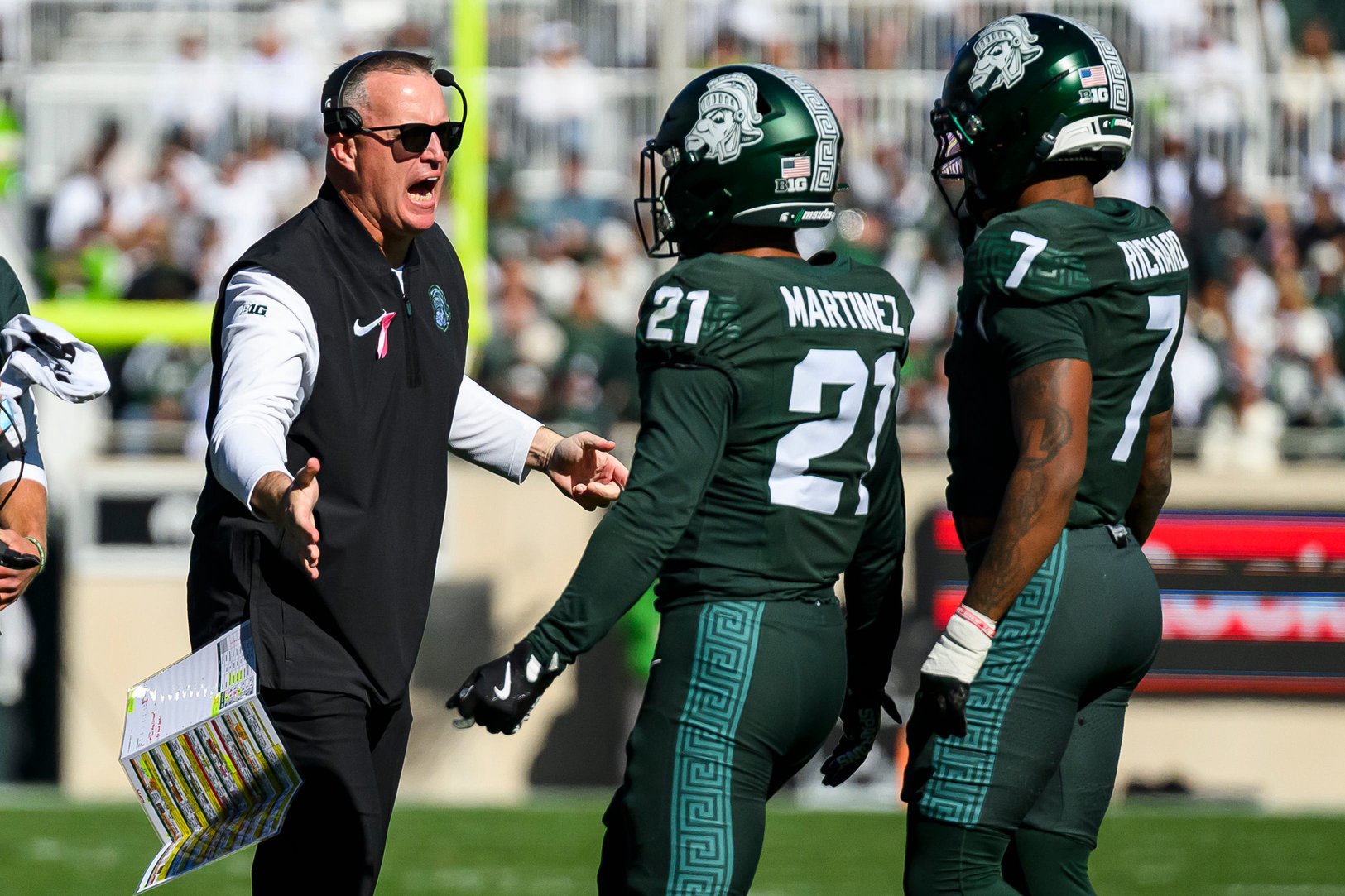 Michigan State head coach Pat Fitzgerald speaks with defensive back Nikai Martinez and Michigan State safety Michael Richard during the first half against Northwestern.