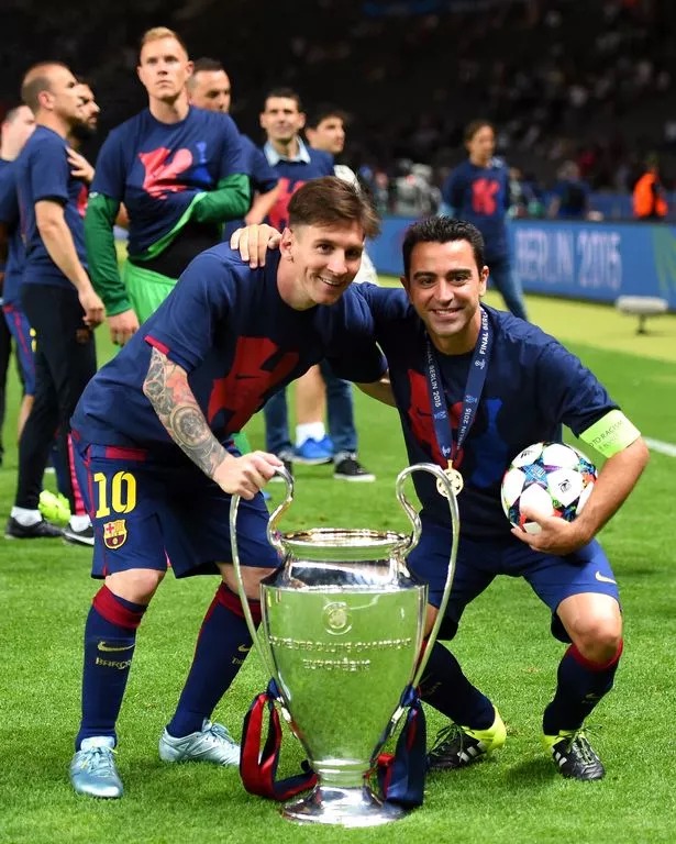 BERLIN, GERMANY - JUNE 06: Lionel Messi and Xavi Hernandez of Barcelona celebrate with the trophy after the UEFA Champions League Final between Juventus and FC Barcelona at Olympiastadion on June 6, 2015 in Berlin, Germany.