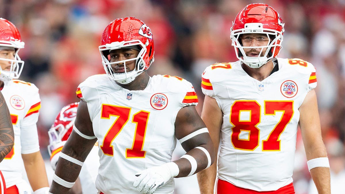 Josh Simmons and Travis Kelce of the Kansas City Chiefs line up during a preseason NFL game against the Arizona Cardinals.