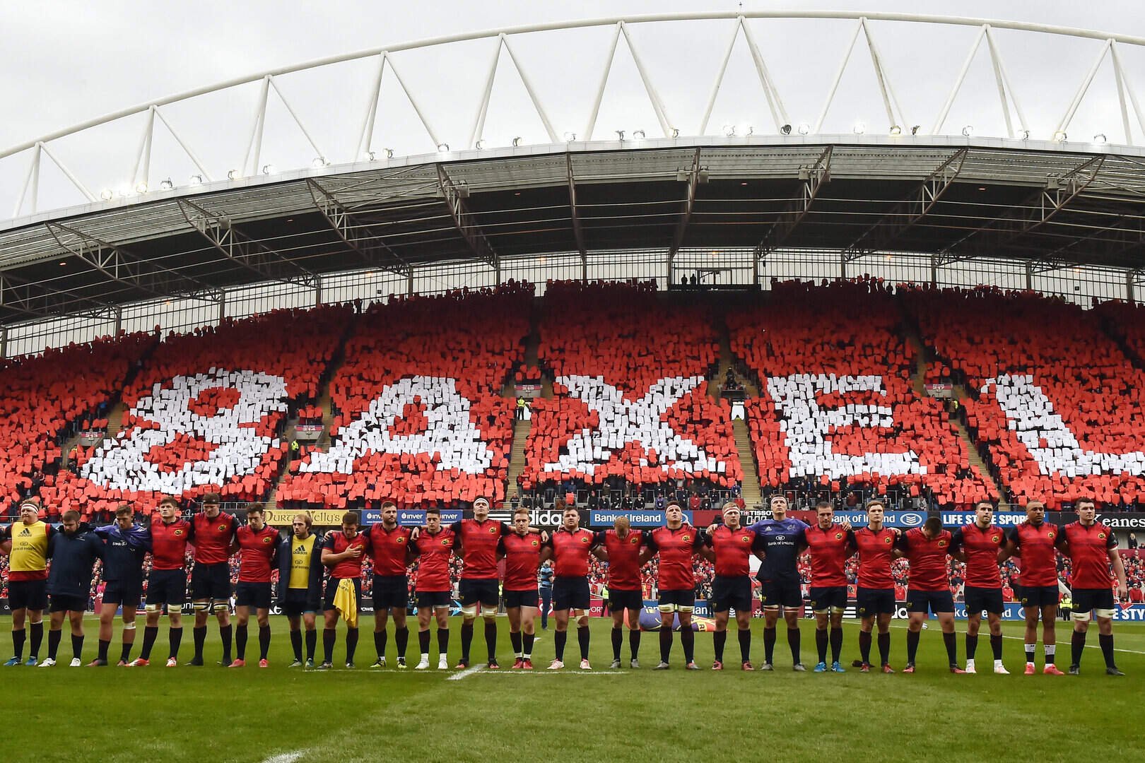 The Munster team during a minute's silence in memory of Anthony Foley before the Champions Cup game against Glasgow Warriors at Thomond Park in 2016