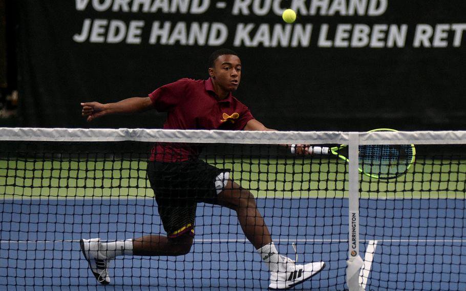 Aiden Threatt volleys at the net.