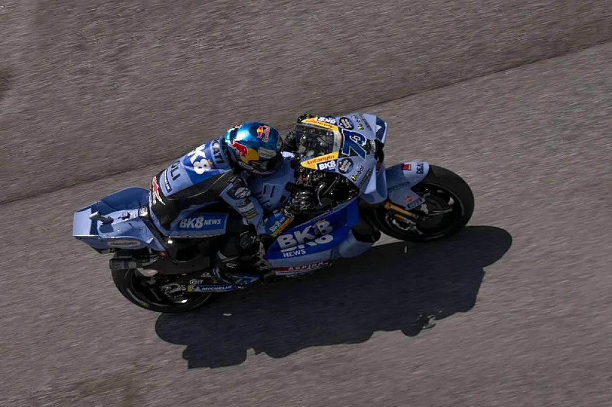 Rider in blue BK8 News MotoGP leathers and helmet on a blue Ducati, leaning into a corner at Sepang, Malaysian MotoGP