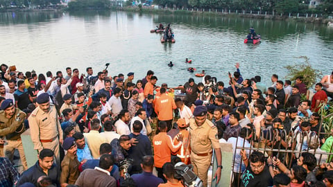 People gather during a rescue and search operation after the Vadodara Harani Lake tragedy