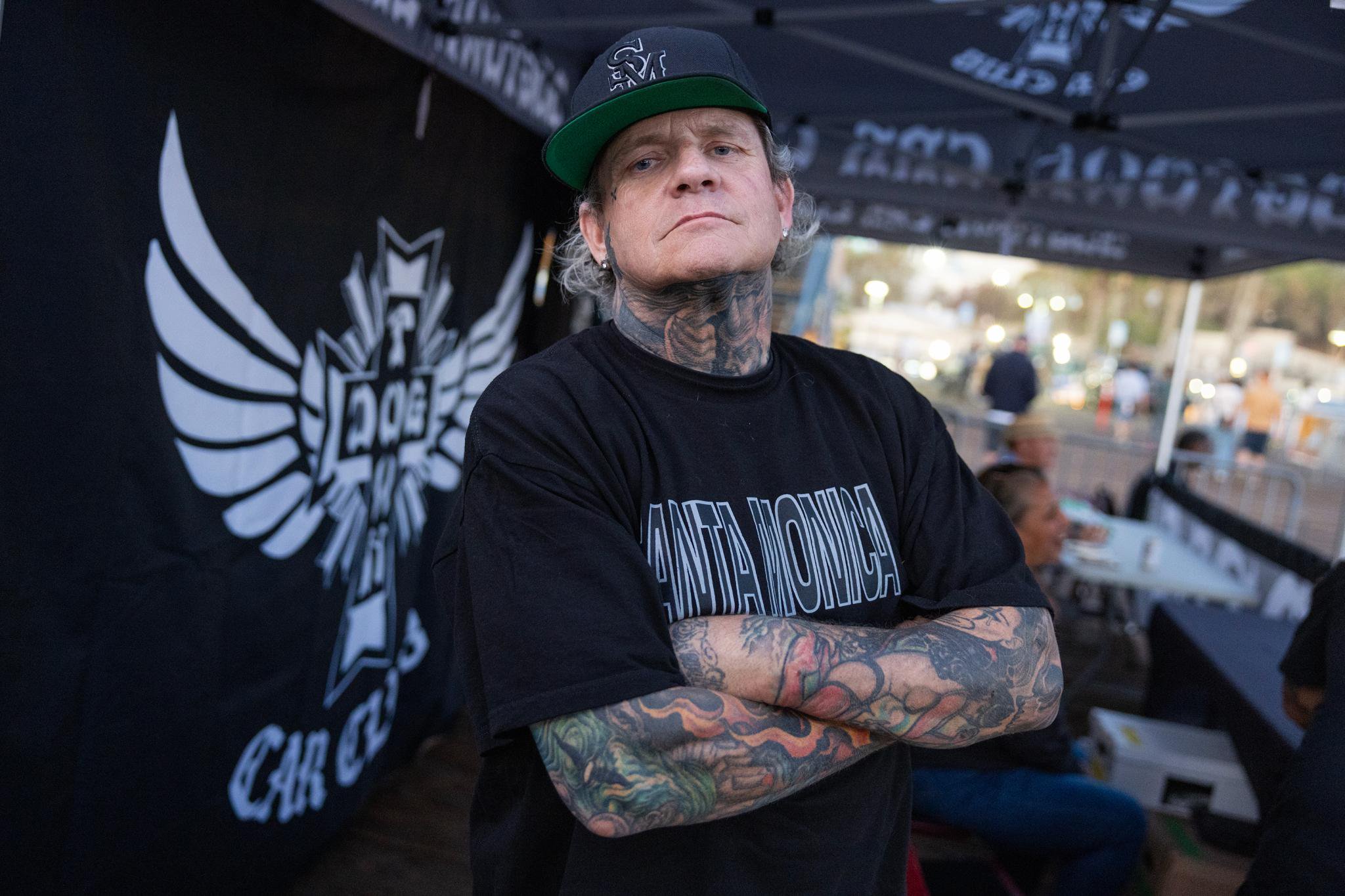Jason Brown of the Dogtown Car Club poses with his arms crossed at the Santa Monica Pier.