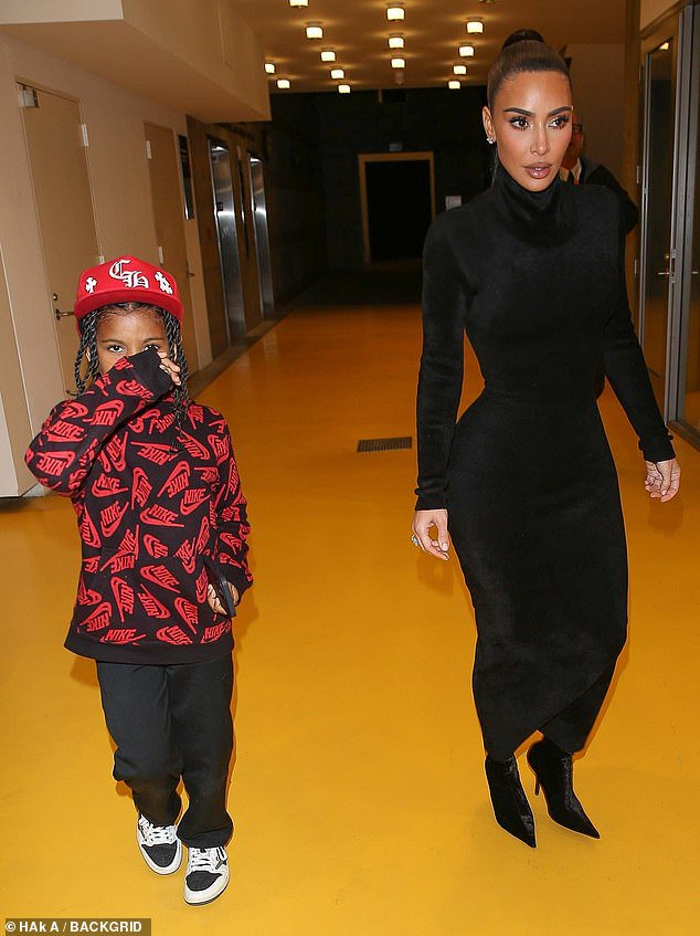 Elegant: The superstar's black stiletto boots matched her fashionable dress and she wore her raven hair up in an elegant high ponytail