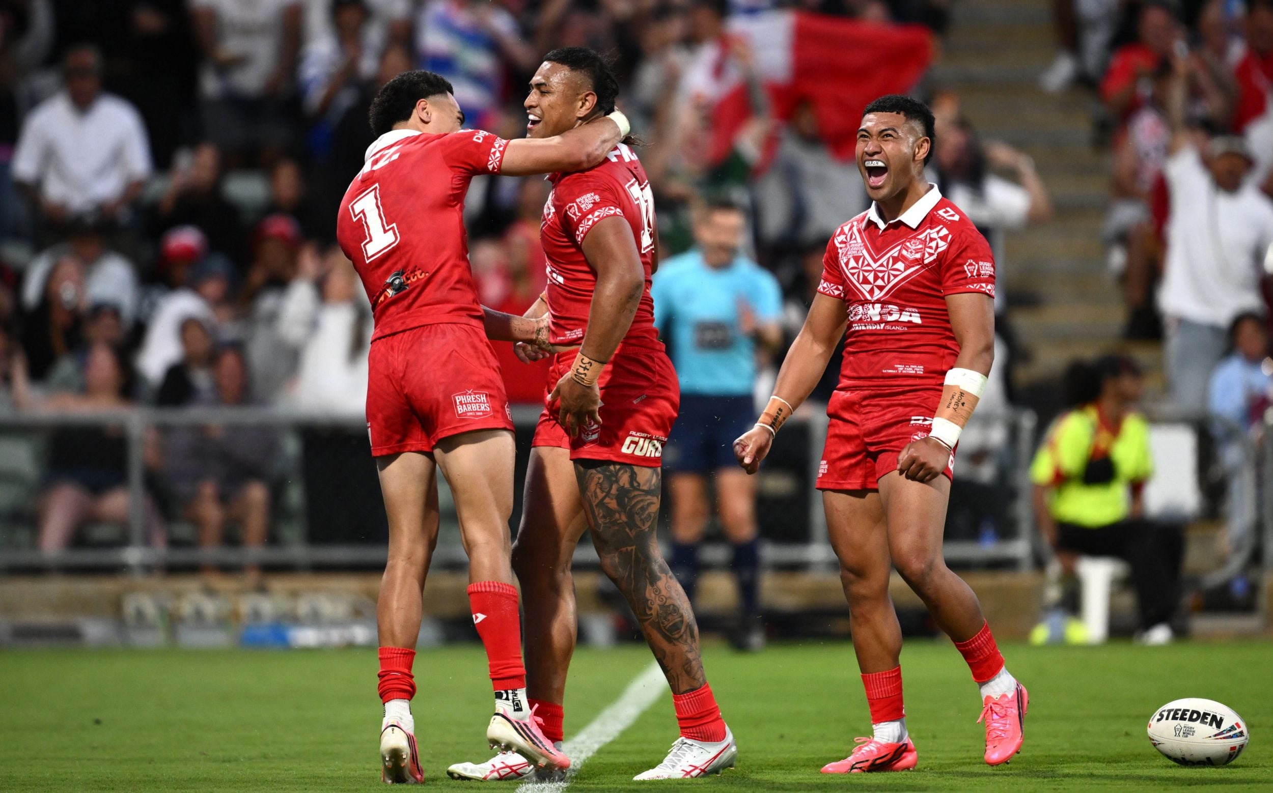Lehi Hopoate of Tonga (L) celebrates with try scorer Haumole Olakau'atu (C) during the Men's Rugby League World Cup Group A match between England and Tonga at HBF Park in Perth, Australia, 17 October 2026. Men's Rugby League World Cup - England vs Tonga, Perth, Australia - 17 Oct 2026